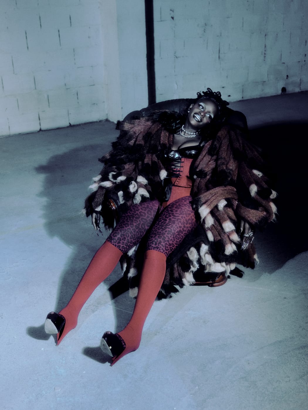 Ezek sprawled in the armchair under the fur, red tights kicked out, blue light